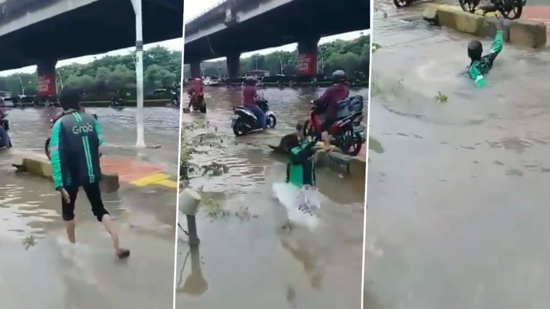 सावधानी हटी दुर्घटना घटी! पानी से लबालब भरी सड़क पर मोबाइल देखकर चलना शख्स को पड़ा भारी, नाले में गिरा धड़ाम से… (Watch Viral Video)