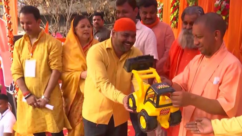 गोरखपुर में होली के रंग में सराबोर दिखे CM योगी आदित्यनाथ, तभी मंच पर आकर शख्स ने भेंट किया बुलडोजर