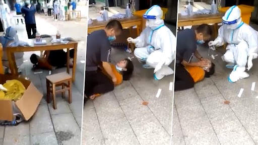 Viral Video: चीन में महिला को COVID टेस्ट के लिए जमीन पर जबरदस्ती लिटाकर लिया गया स्वैब सैंपल, देखें वीडियो