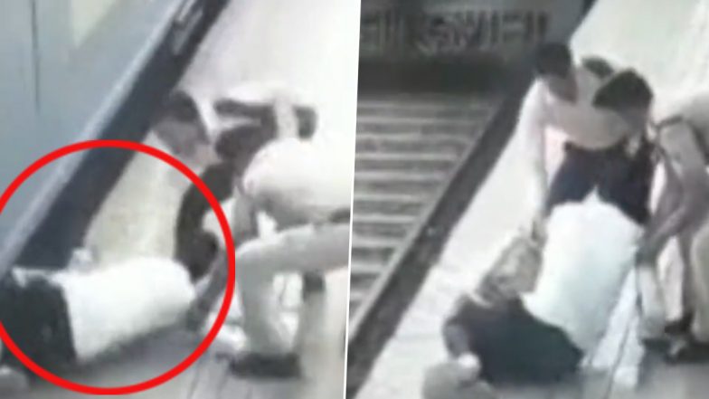 आरपीएफ जवान और मुस्तैद नागरिक ने ट्रेन के नीचे गिरने से शख्स को बचाया (Watch Video)