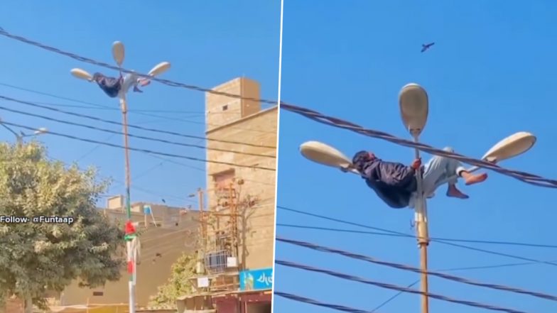 Viral Video: बिजली के खंभे पर लेटकर आराम फरमाता दिखा शख्स, इस नजारे ने उड़ाए लोगों के होश