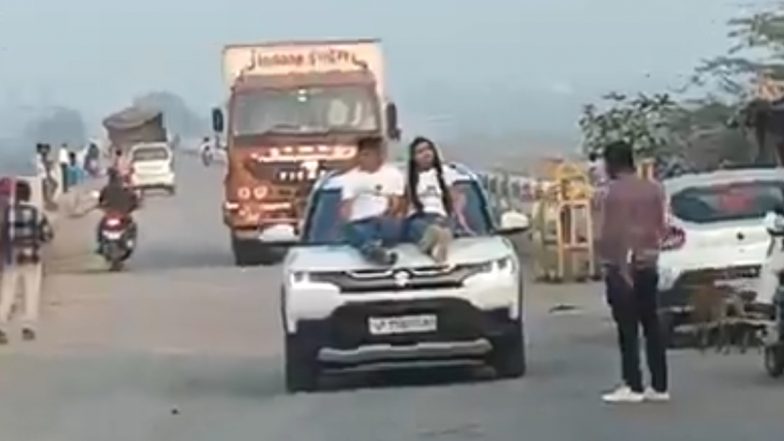 Viral Video: रील बनाने के लिए उड़ाई नियमों की धज्जियां! कानपुर में कार के बोनट पर बैठकर बनाई रील, बीच सड़क पर स्टंट
