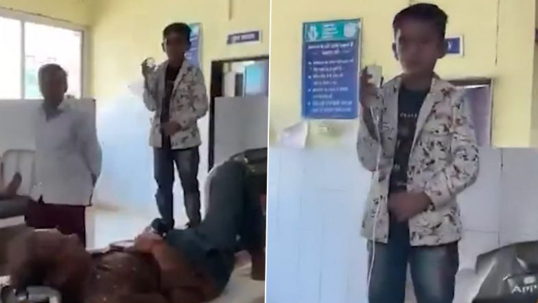 Tikamgarh Hospital Video: पिता को चढ़ाई जा रही थी सलाइन, स्टैंड नहीं होने से मासूम के हाथों में थमा दी बोतल, टीकमगढ़ के जिला हॉस्पिटल का वीडियो आया सामने