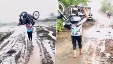 120KG Motorcycle on Shoulder: बारिश के कारण किसान के 25 वर्षीय बेटे ने कंधे पर उठाई बाइक, इंटरनेट पर वीडियो हुआ वायरल
