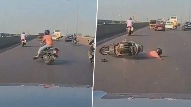 VIDEO: वाहन चालक की लापरवाही! स्कूटी चलाते हुए देख रहा था मोबाइल, गाड़ी के साथ सड़क पर गिरा, अहमदाबाद का वीडियो आया सामने