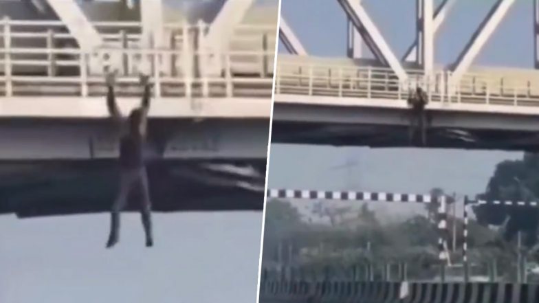 VIDEO: हापुड़ में जानलेवा स्टंट! दिल्ली-लखनऊ हाईवे पर बने ब्रिज से लटककर युवक कर रहा है एक्सरसाइज